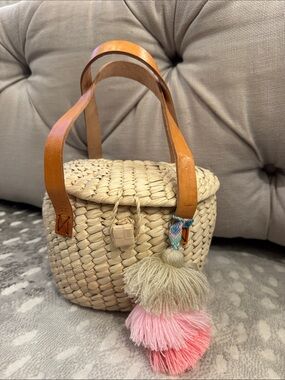 Cream Woven Mini Basket Bag with Tan Leather Handles and Pink Tassel